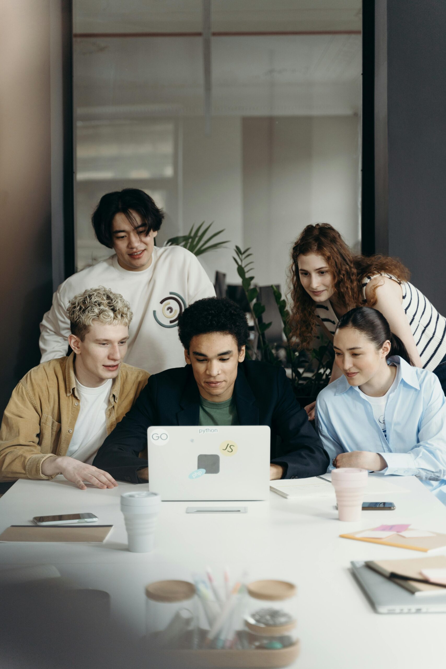 Multiracial team collaborating on a project in a modern office setting.